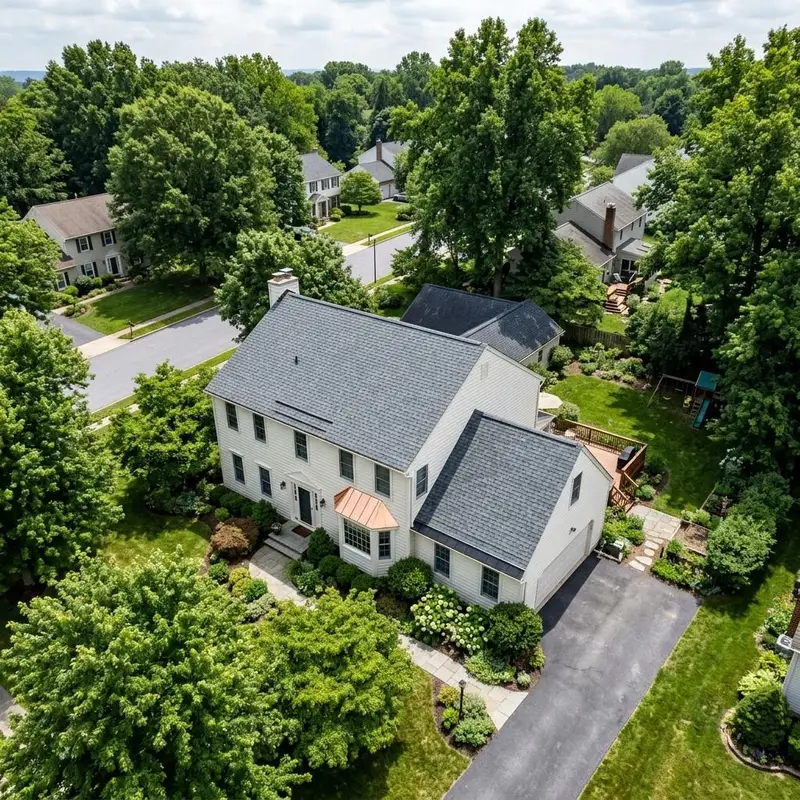 Colonial home with a slate gray shingle roof and a copper bay window roof